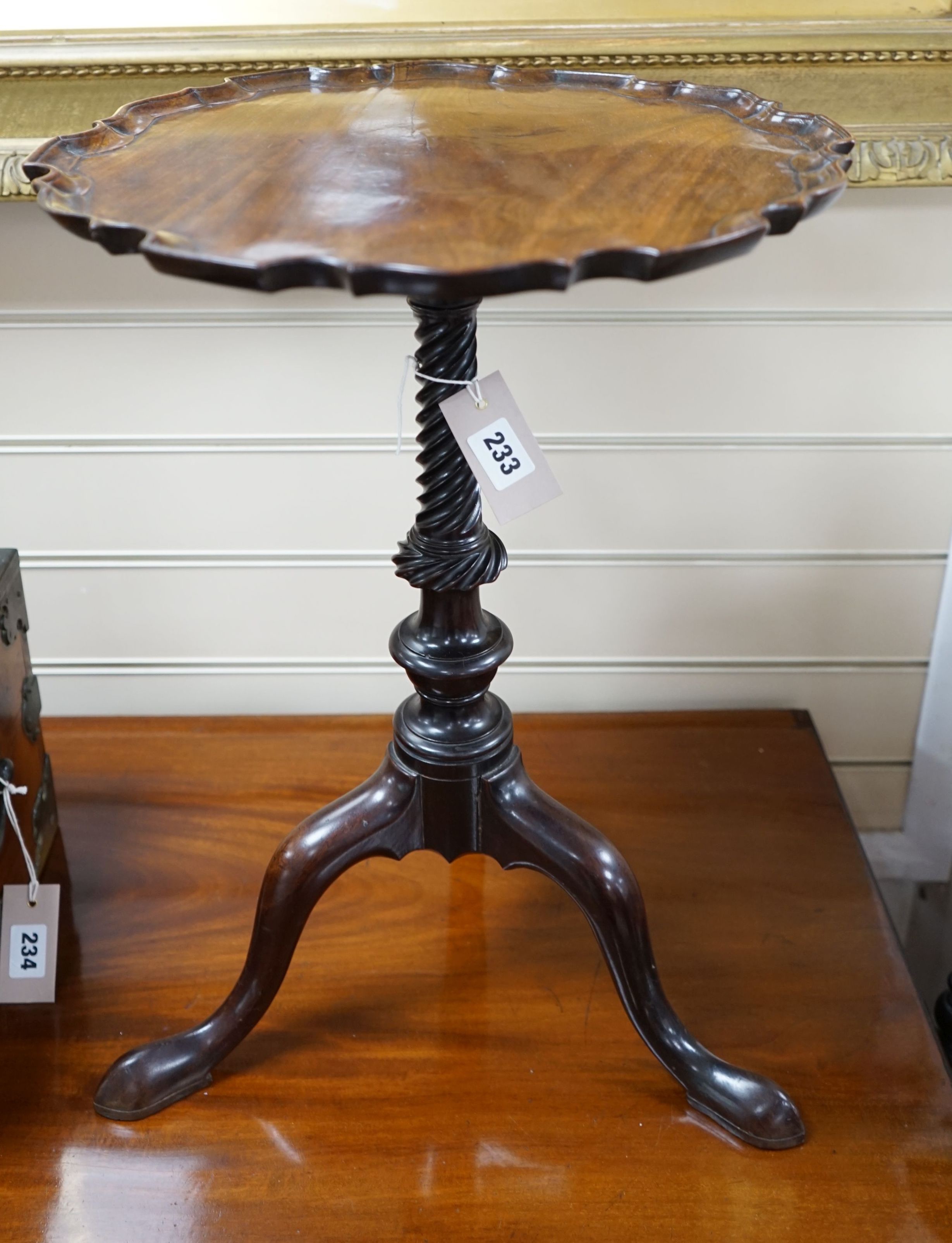 A George III and later mahogany tripod wine table, with circular piecrust top and spiral fluted stem on cabriole tripod base with pointed pad feet, diameter 38cm height 52cm